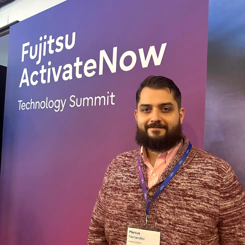 Haneke employee in front of summit sign