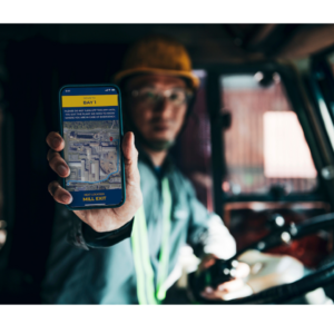 truck driver holding phone showing check-in application