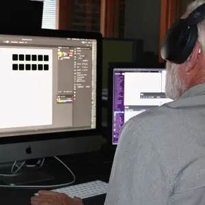 man on computer, screen showing Adobe XD 